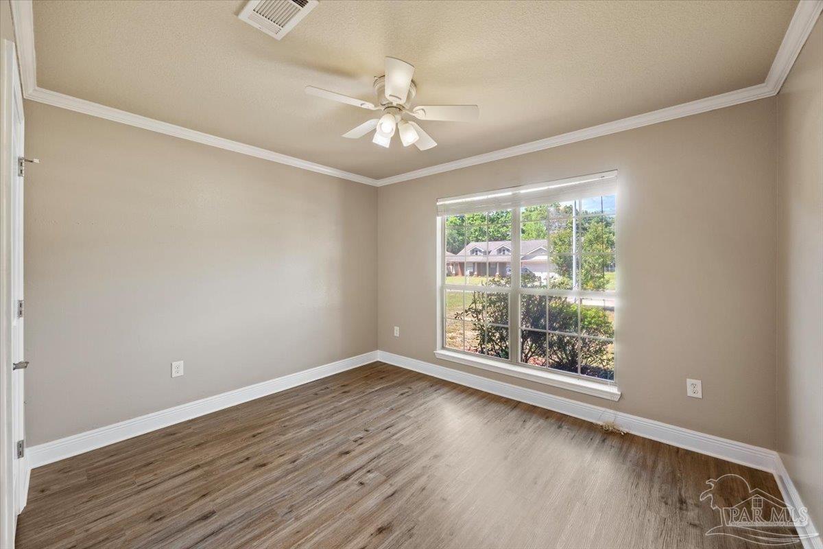 4015 Berry Circle Pace, FL 32571 - Photo 27 of 48 an empty room with wooden floor fan and windows