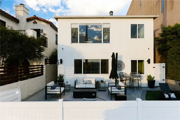 a front view of a house with sitting area