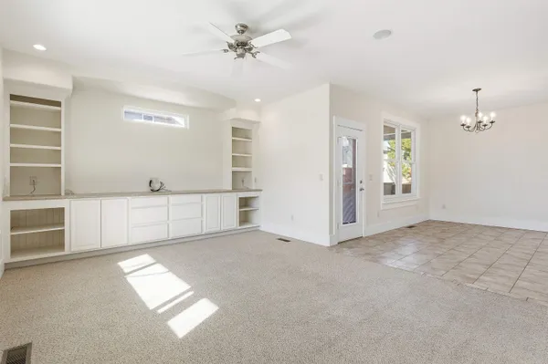 a bedroom with a bed a dresser and chair