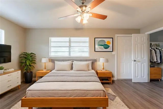 a bedroom with a bed and a flat screen tv