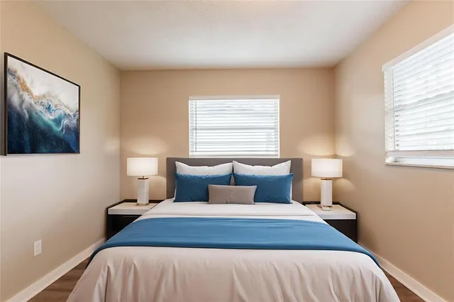 a bedroom with a bed and a painting on the wall