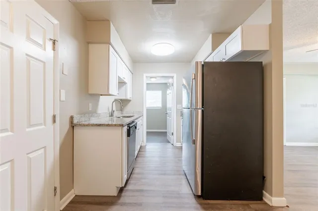 a kitchen with a refrigerator and a sink