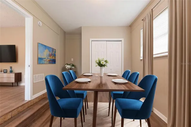 a view of a dining room with furniture window and wooden floor