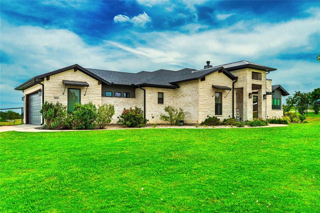 1024 Henry Way Springtown, TX 76082 - Photo 27 of 29 Contemporary exterior with light-toned stone masonry and dark trim accents