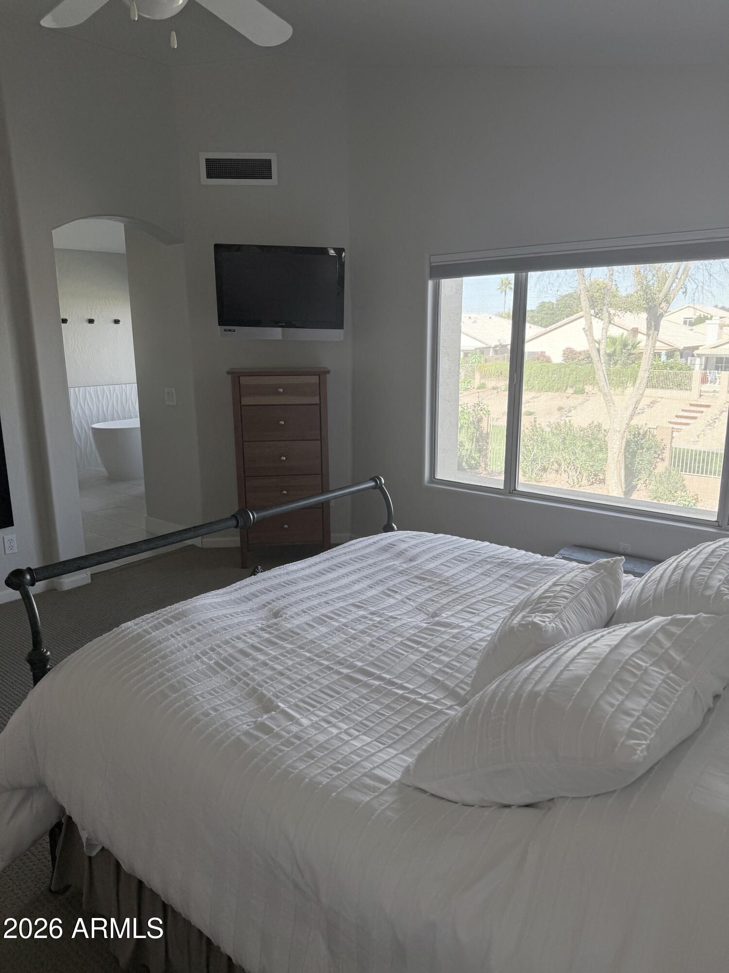 3426 East Clark Road Phoenix, AZ 85050 - Photo 22 of 48 a bedroom with a bed and a large window