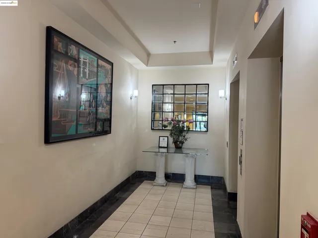 a view of a hallway with wooden floor windows and a kitchen