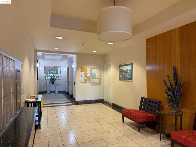 a lobby with furniture and potted plants