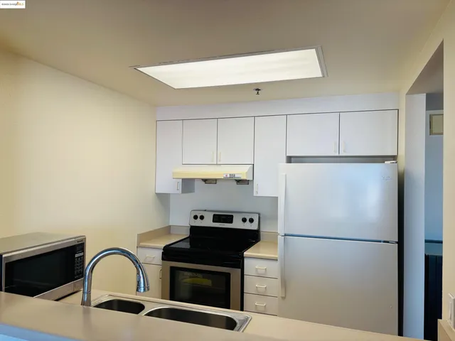 a white refrigerator freezer sitting in a kitchen