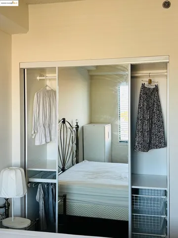 a bedroom with a bed and a lamp with window