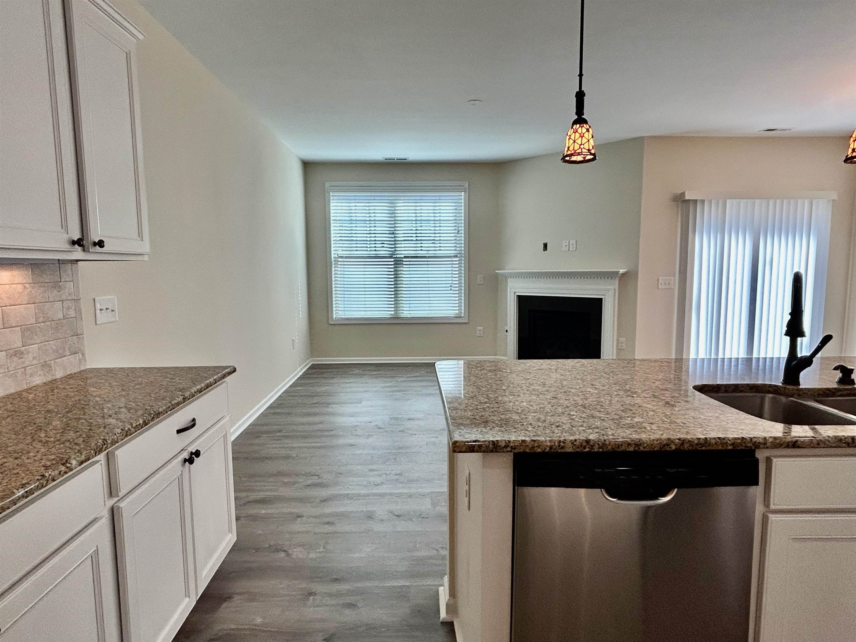 7804 Elmshire Way Raleigh, NC 27616 - Photo 15 of 41 a kitchen with granite countertop a sink a counter top space and cabinets