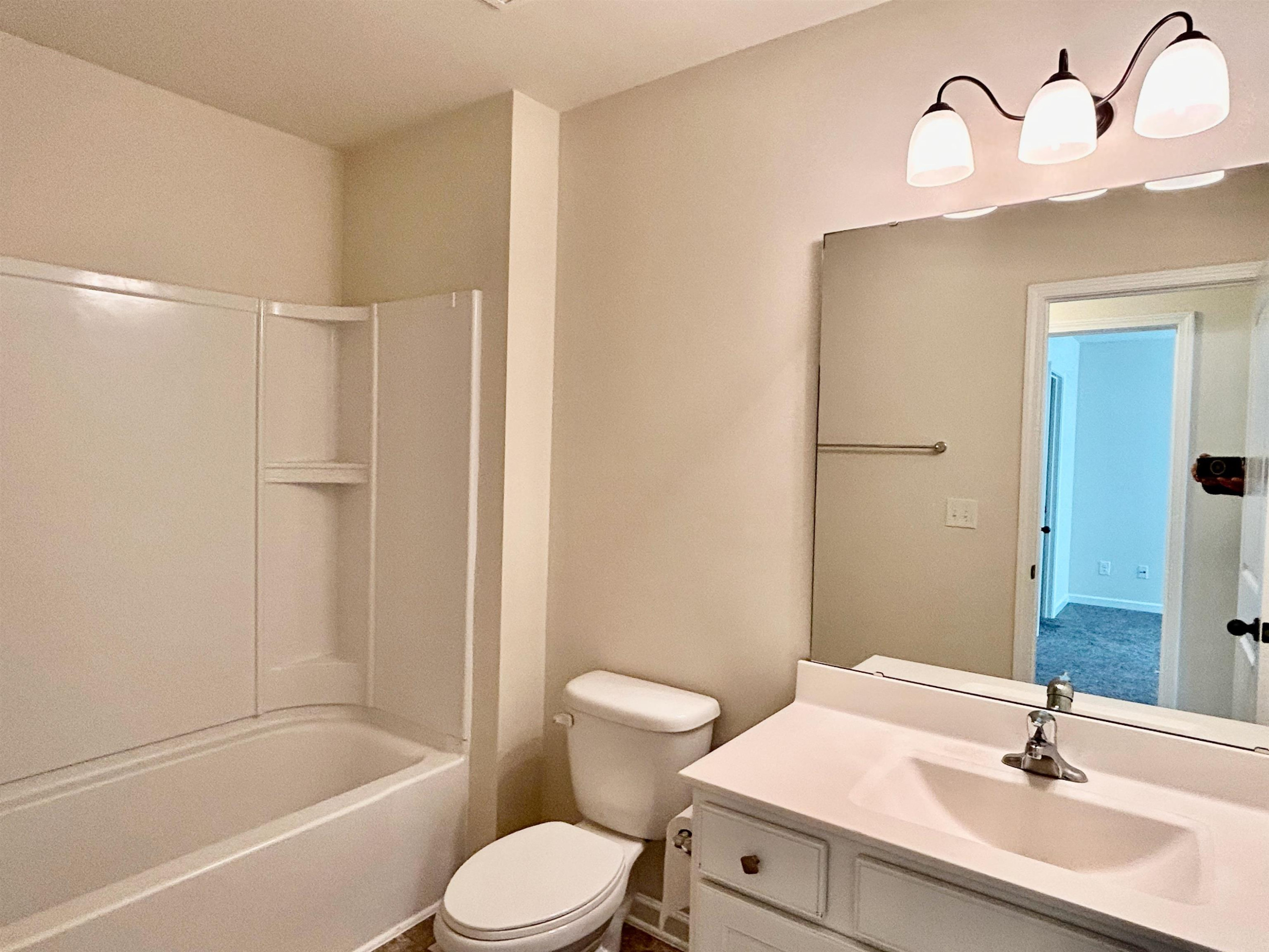 7804 Elmshire Way Raleigh, NC 27616 - Photo 22 of 41 a bathroom with a sink toilet and shower