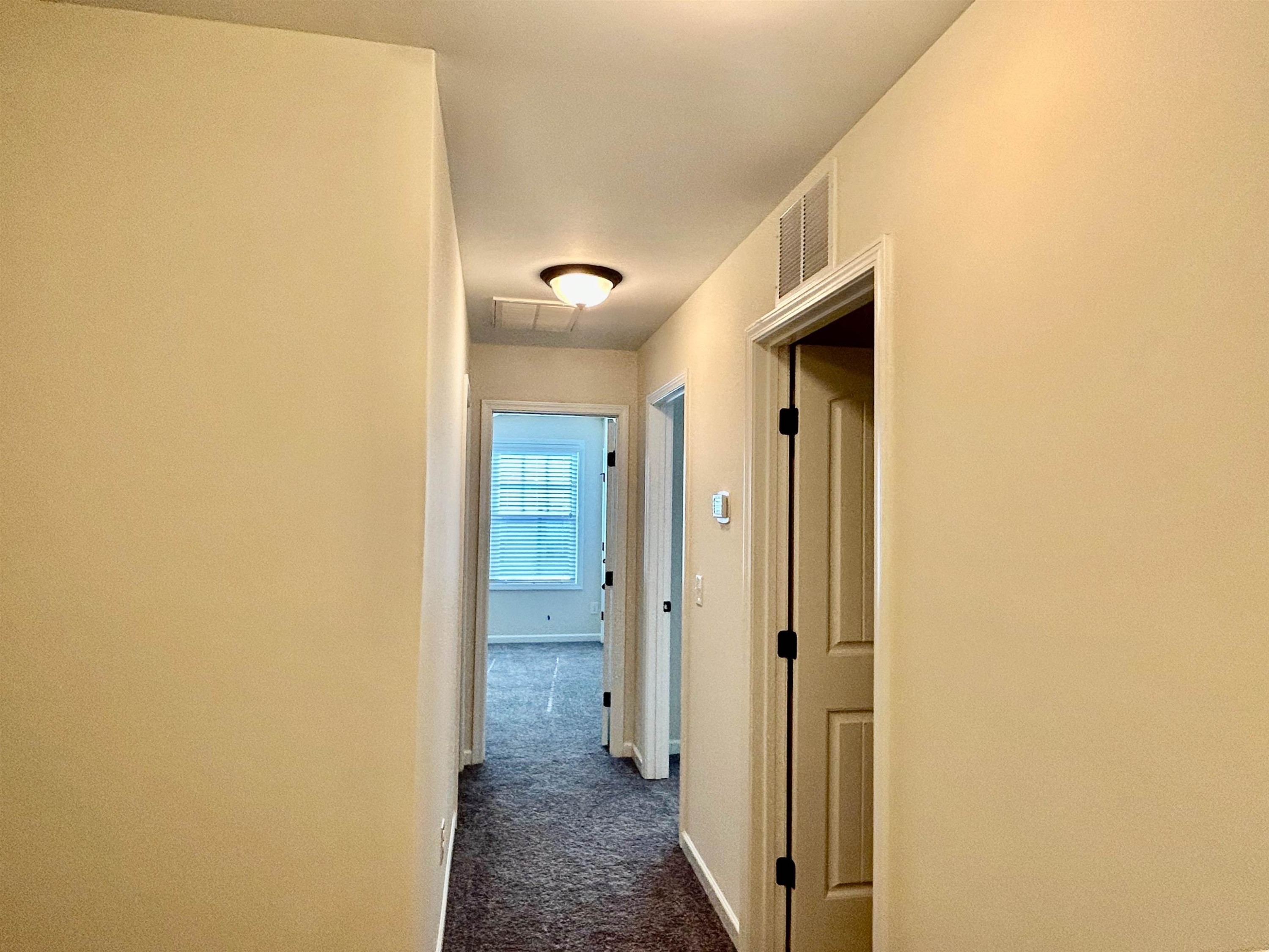 7804 Elmshire Way Raleigh, NC 27616 - Photo 25 of 41 a view of a hallway with wooden floor