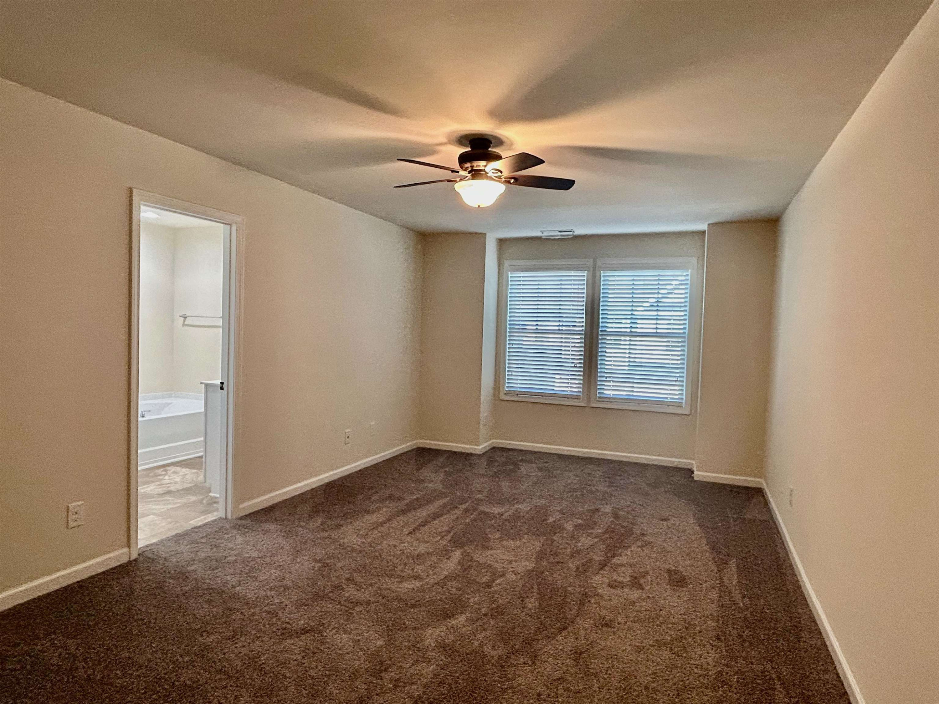 7804 Elmshire Way Raleigh, NC 27616 - Photo 28 of 41 an empty room with windows and fan