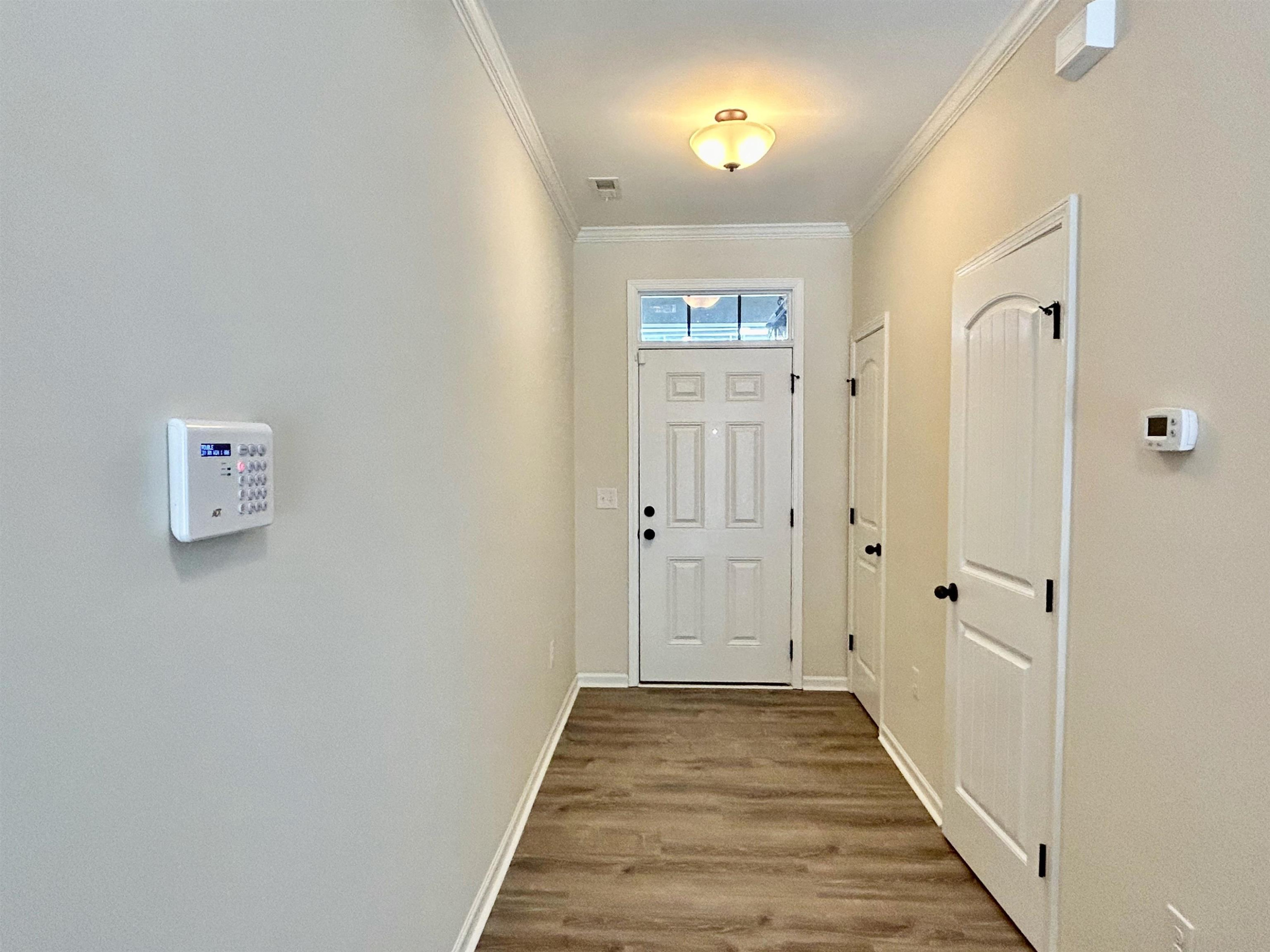 7804 Elmshire Way Raleigh, NC 27616 - Photo 3 of 41 a view of a hallway with wooden floor and closet area