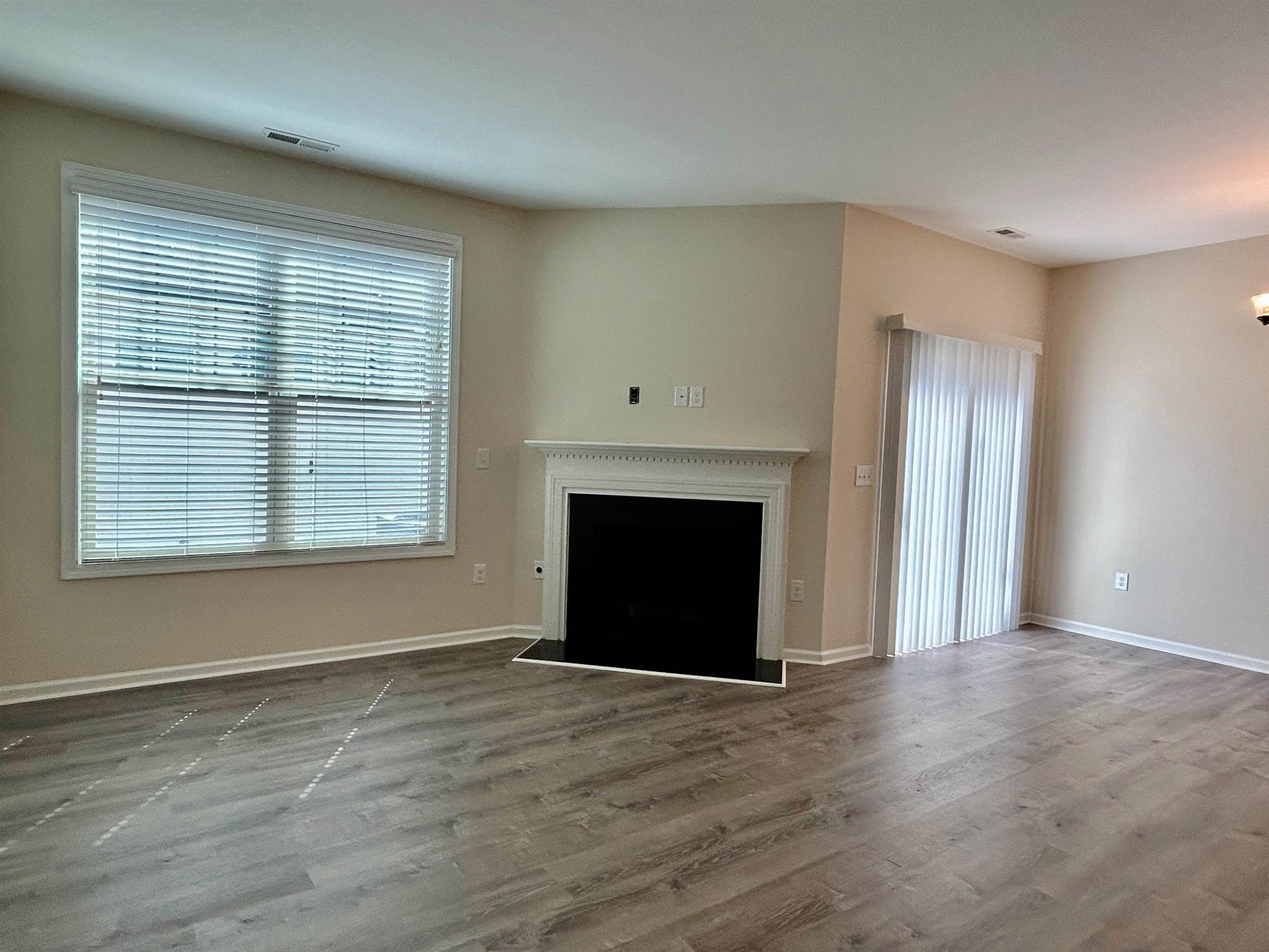 7804 Elmshire Way Raleigh, NC 27616 - Photo 7 of 41 a view of an empty room with a window and fireplace