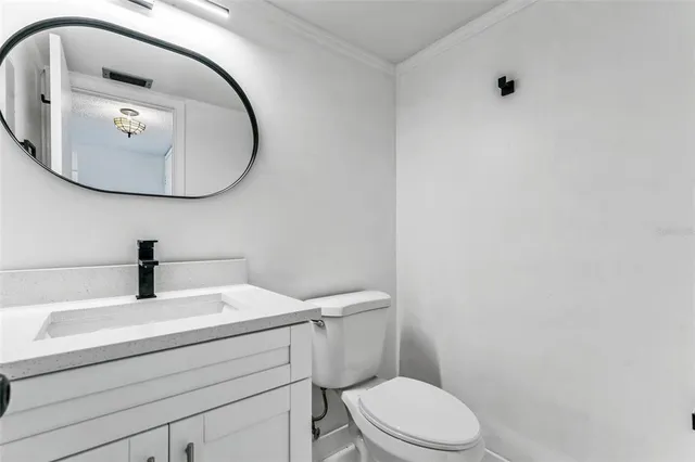 a bathroom with a sink mirror and toilet