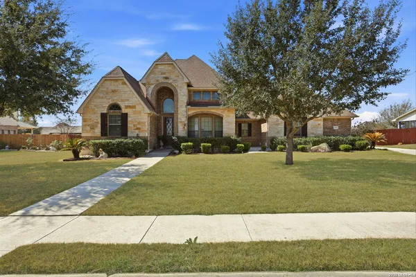 a front view of a house with a yard
