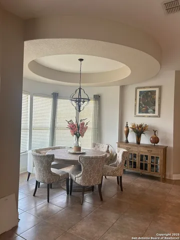 a view of a dining room with furniture and chandelier