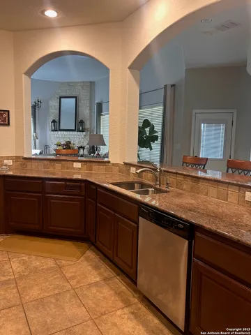 a kitchen with stainless steel appliances granite countertop a sink and cabinets