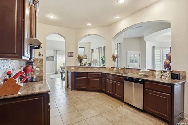 a large bathroom with a granite countertop double vanity and a mirror