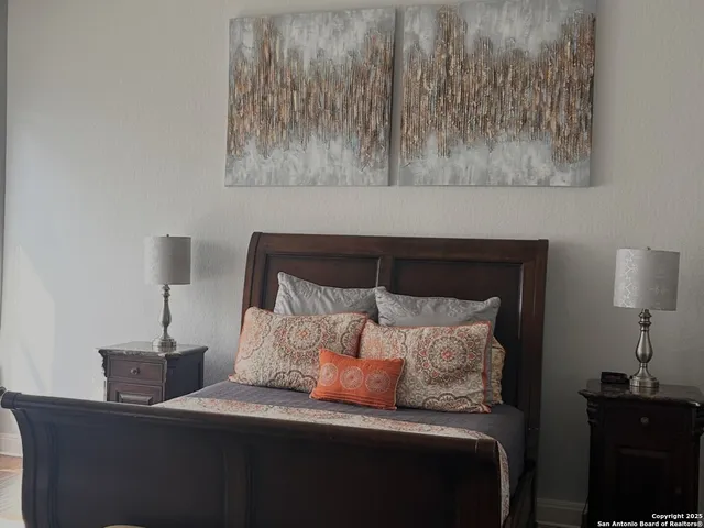 a bedroom with a bed and a lamp on table