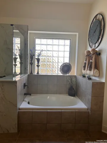 a bathroom with a bathtub and a window