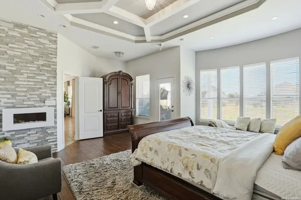 a spacious bedroom with a balcony a bed and a couch