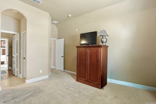 a view of a livingroom with wooden floor and furniture