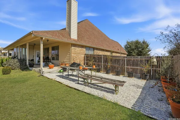 a view of a house with backyard and sitting area
