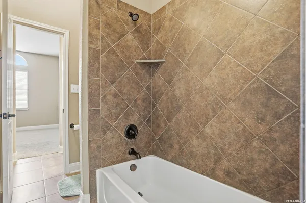 a bathroom with a bathtub and shower