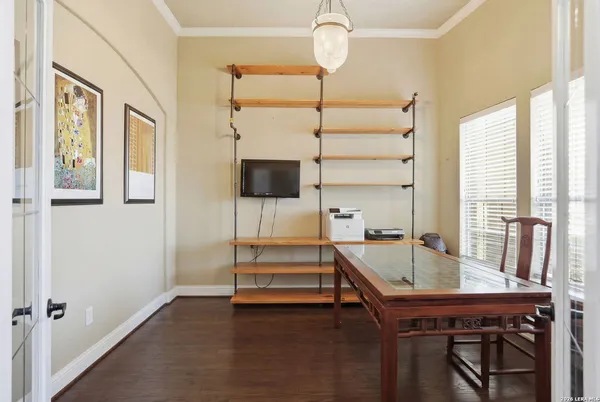 a room with pool table and windows