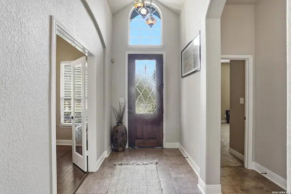 a view of hallway with stairs and wooden floor