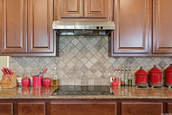 a kitchen with stainless steel appliances granite countertop a sink and cabinets