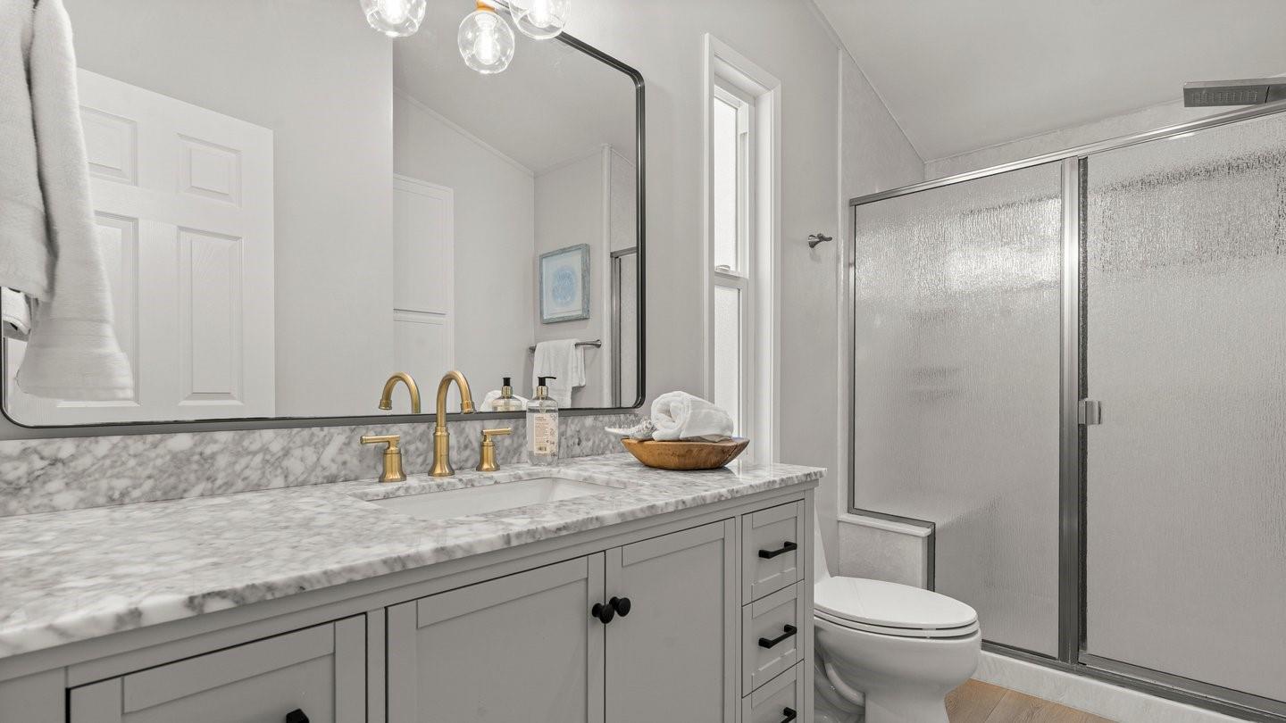14355 La Rinconada Drive Los Gatos, CA 95032 - Photo 20 of 42 a bathroom with a granite countertop sink a toilet and a mirror