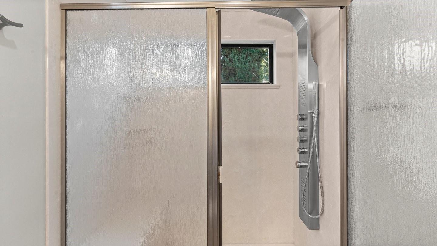 14355 La Rinconada Drive Los Gatos, CA 95032 - Photo 22 of 42 a bathroom with a glass shower door