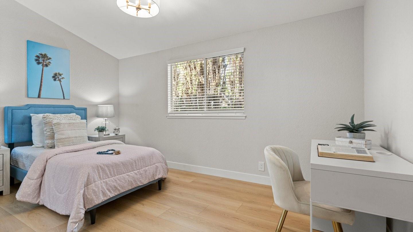 14355 La Rinconada Drive Los Gatos, CA 95032 - Photo 24 of 42 a bedroom with a bed and a table