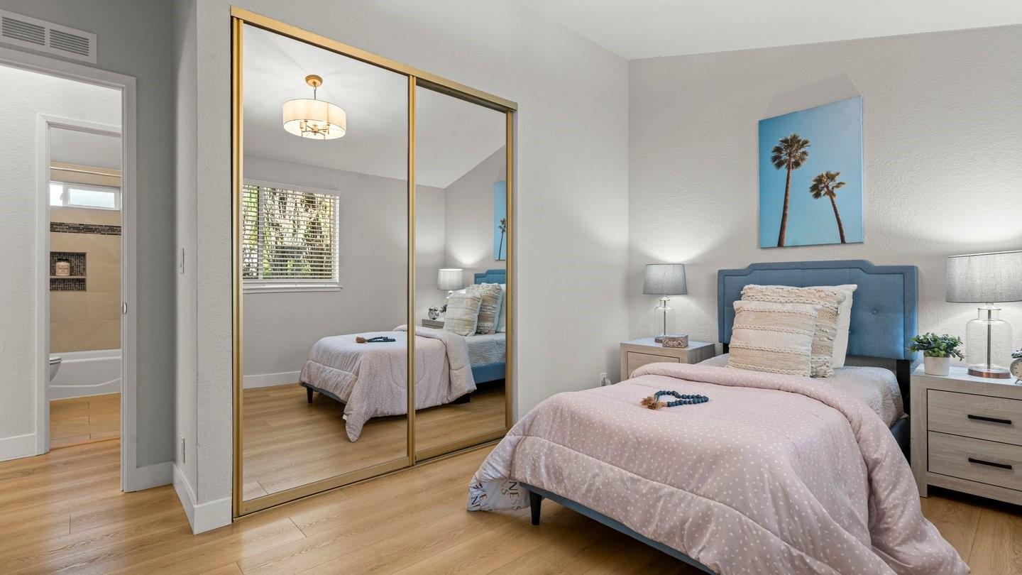 14355 La Rinconada Drive Los Gatos, CA 95032 - Photo 25 of 42 a bedroom with a bed and a mirror