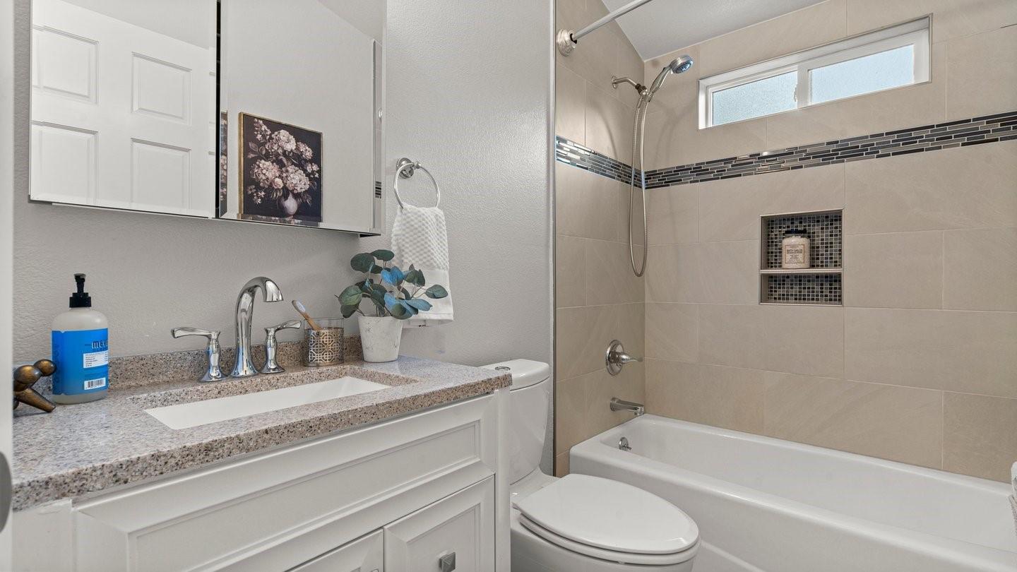 14355 La Rinconada Drive Los Gatos, CA 95032 - Photo 26 of 42 a bathroom with a granite countertop sink a toilet and bathtub