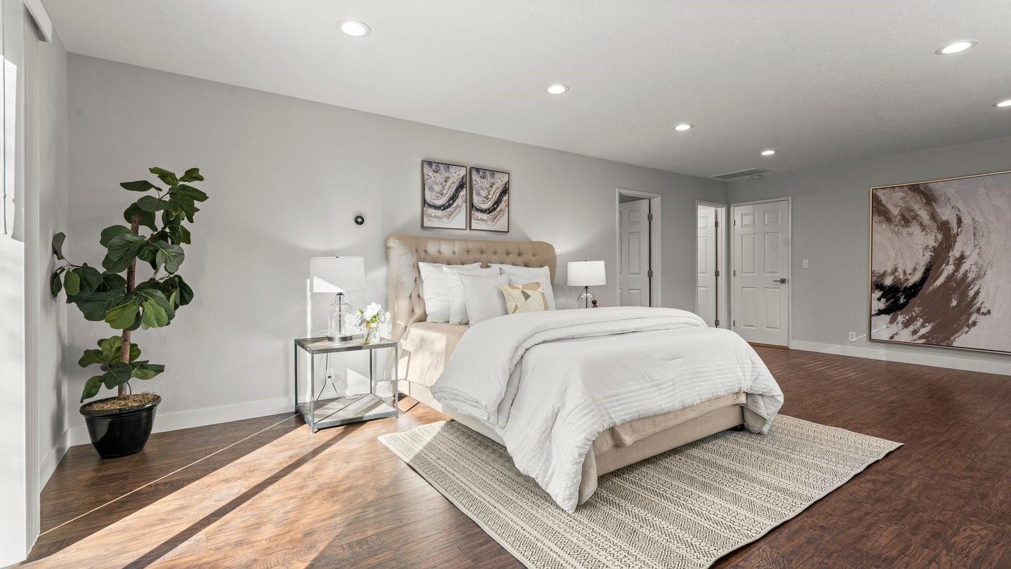 14355 La Rinconada Drive Los Gatos, CA 95032 - Photo 28 of 42 a bedroom with a large bed and a potted plant