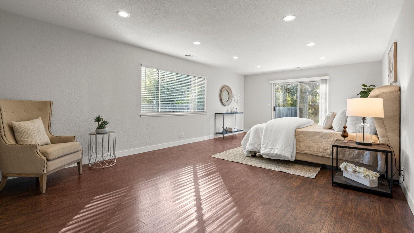 14355 La Rinconada Drive Los Gatos, CA 95032 - Photo 29 of 42 a spacious bedroom with a bed a couch and wooden floor