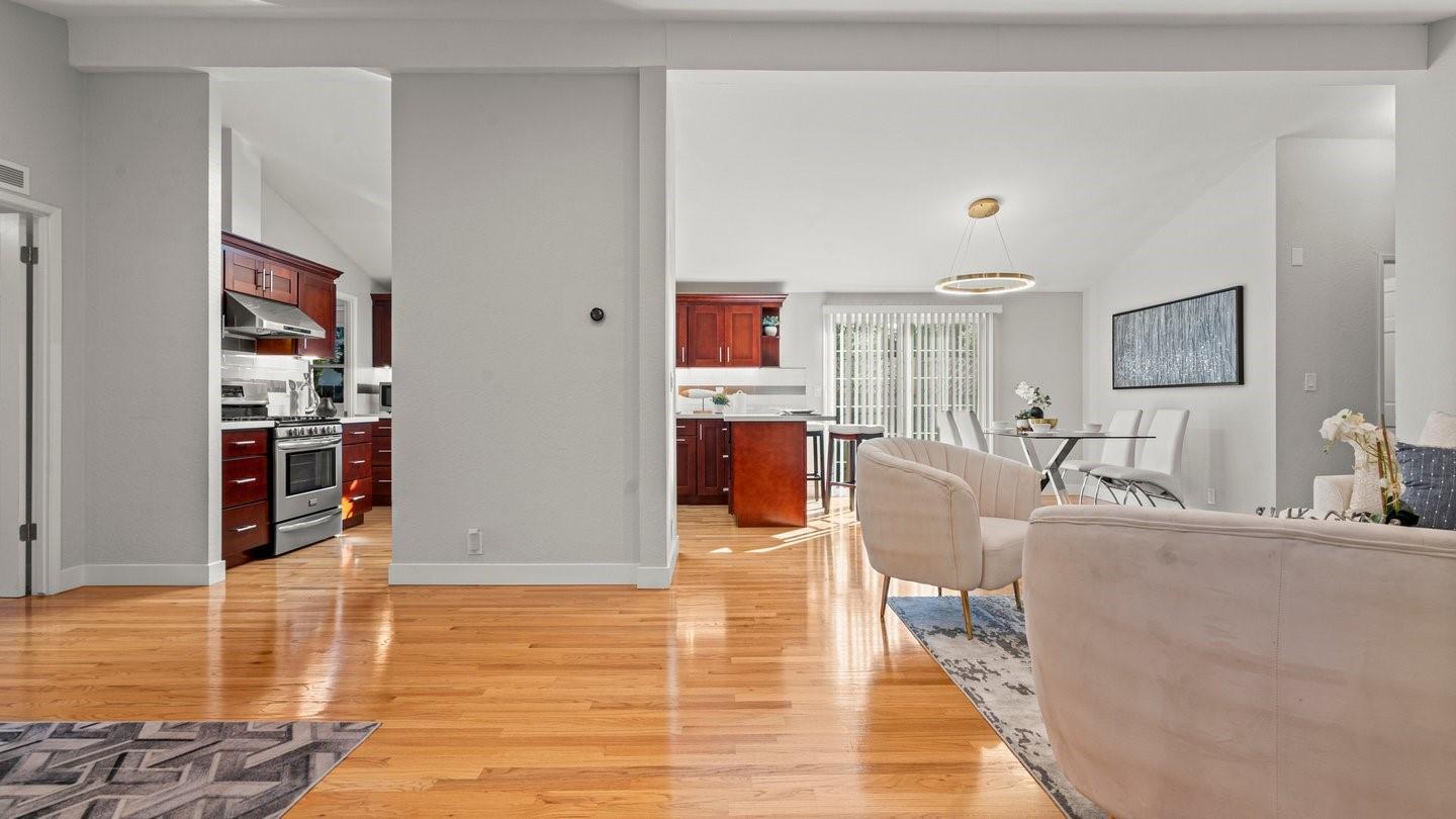 14355 La Rinconada Drive Los Gatos, CA 95032 - Photo 6 of 42 a living room with fireplace furniture and a wooden floor