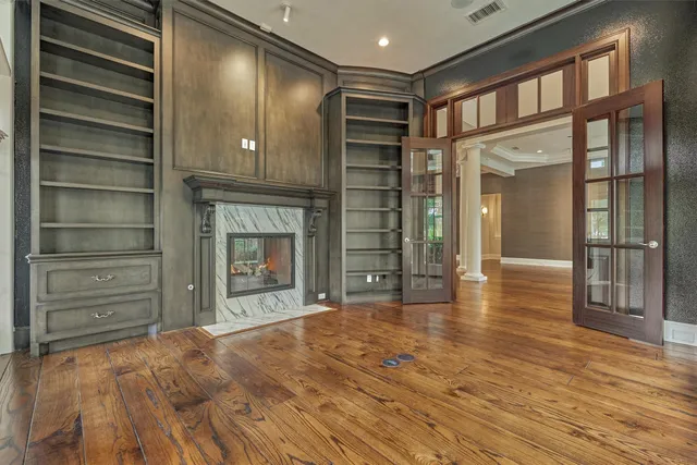 a kitchen with stainless steel appliances granite countertop a table chairs stove a sink dishwasher and cabinets with wooden floor