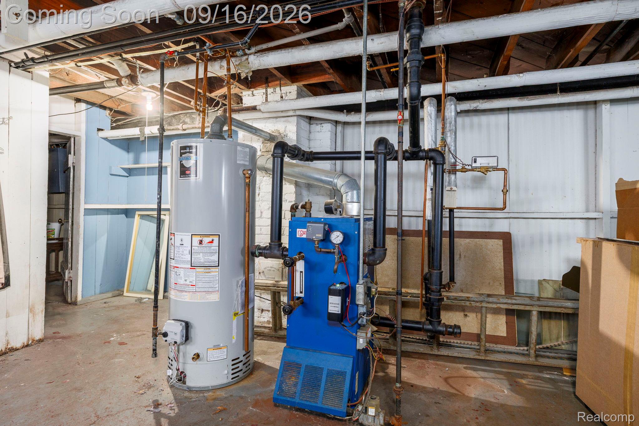 999 Nottingham Road Grosse Pointe, MI 48230 - Photo 25 of 30 Water heater and boiler system with exposed ceiling joists and piping