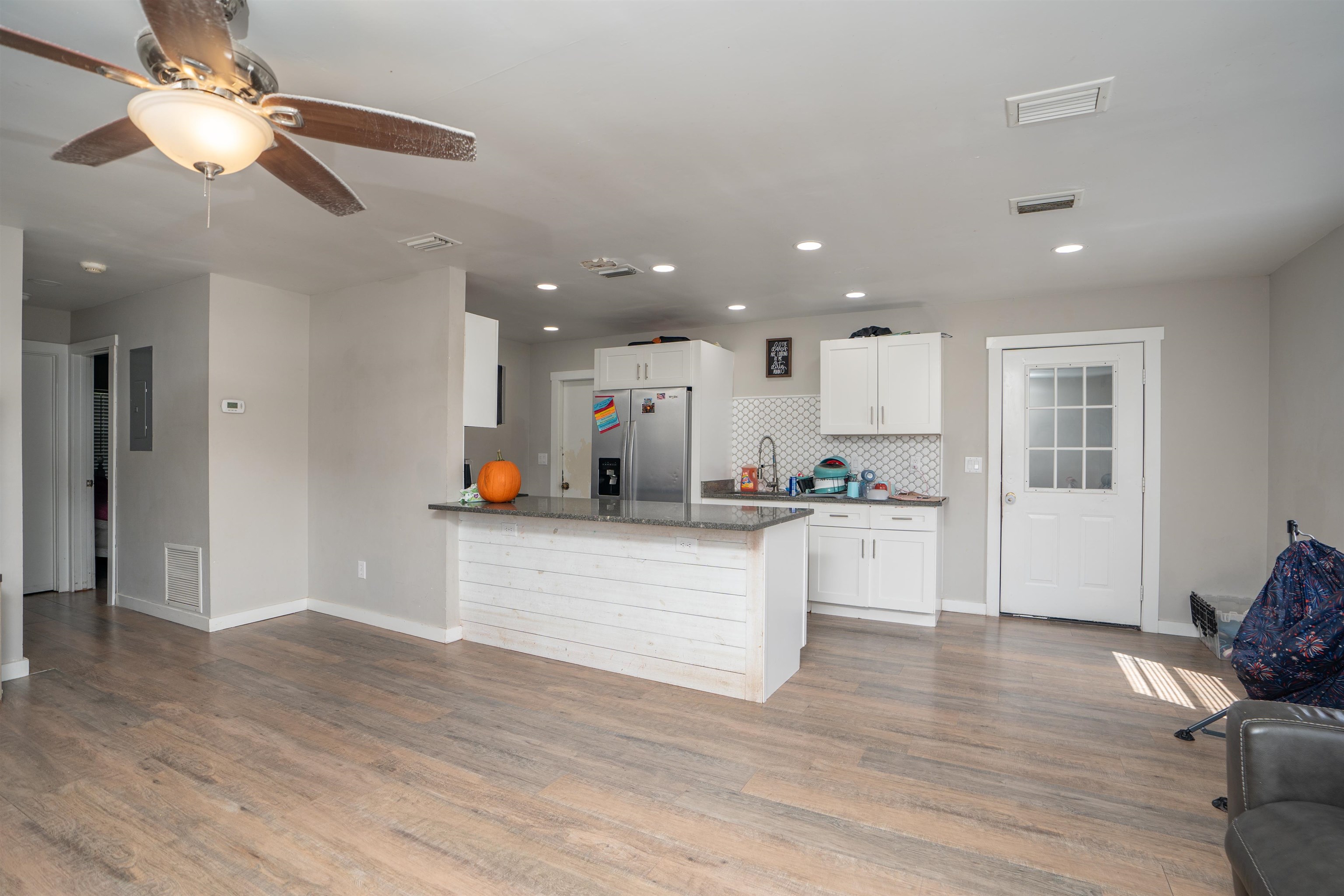 a view of kitchen with stainless steel appliances refrigerator stove microwave and cabinets