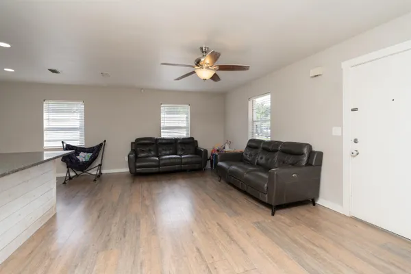 a living room with furniture and kitchen view
