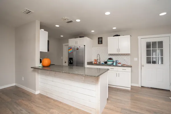 a bedroom with furniture and a large window