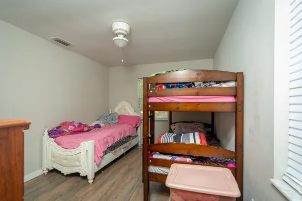 a bathroom with a toilet sink vanity and mirror