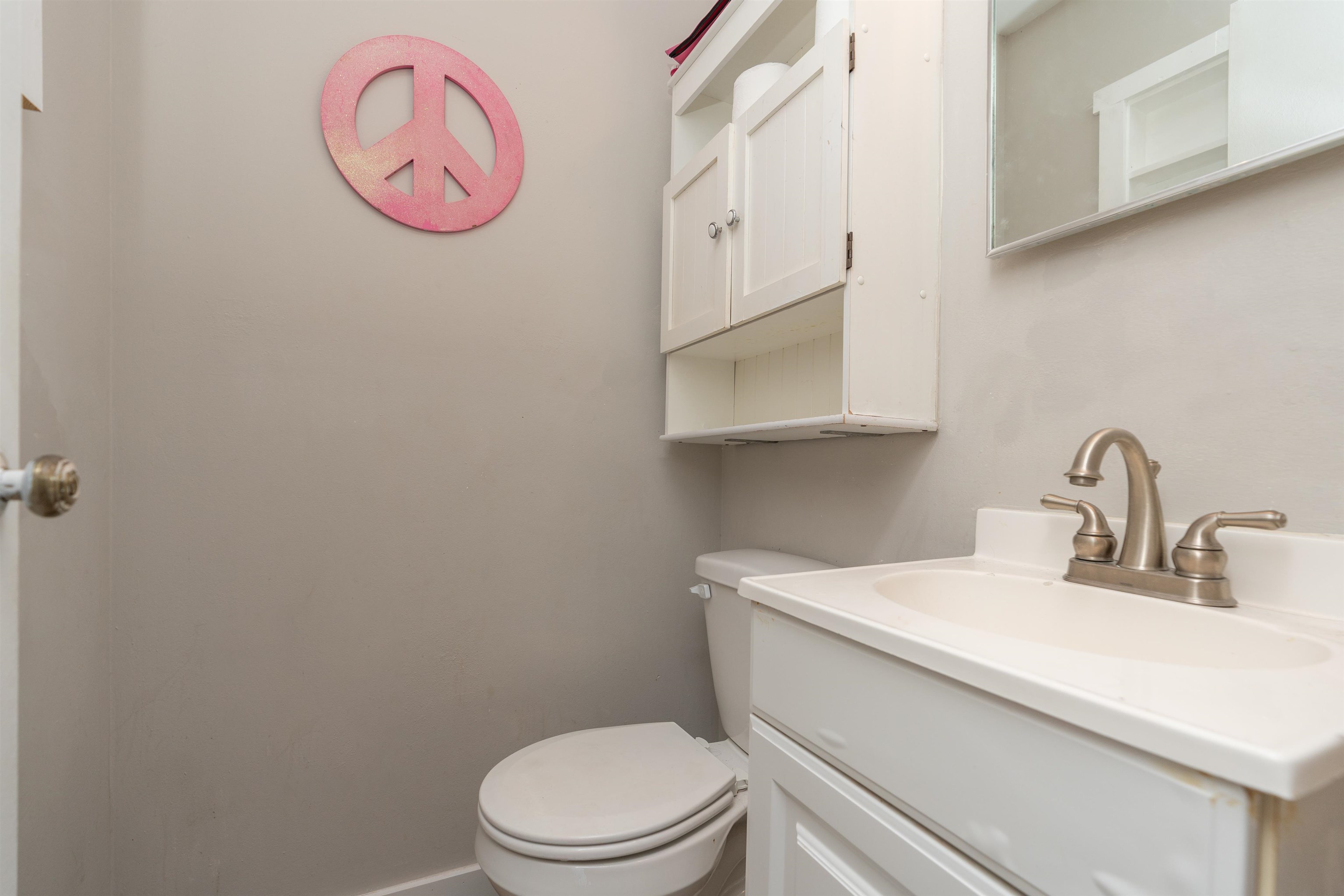 258 Costado Street St. Augustine, FL 32086 - Photo 18 of 39 a bathroom with a toilet sink vanity and mirror