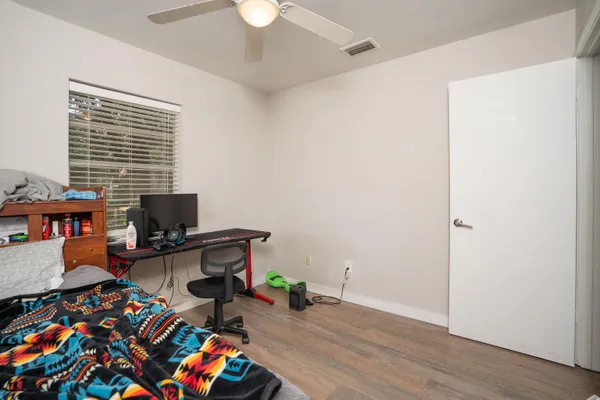 a bathroom with a sink a toilet and shower curtain