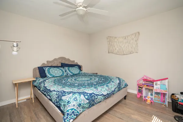 a bedroom with a bed and a chandelier